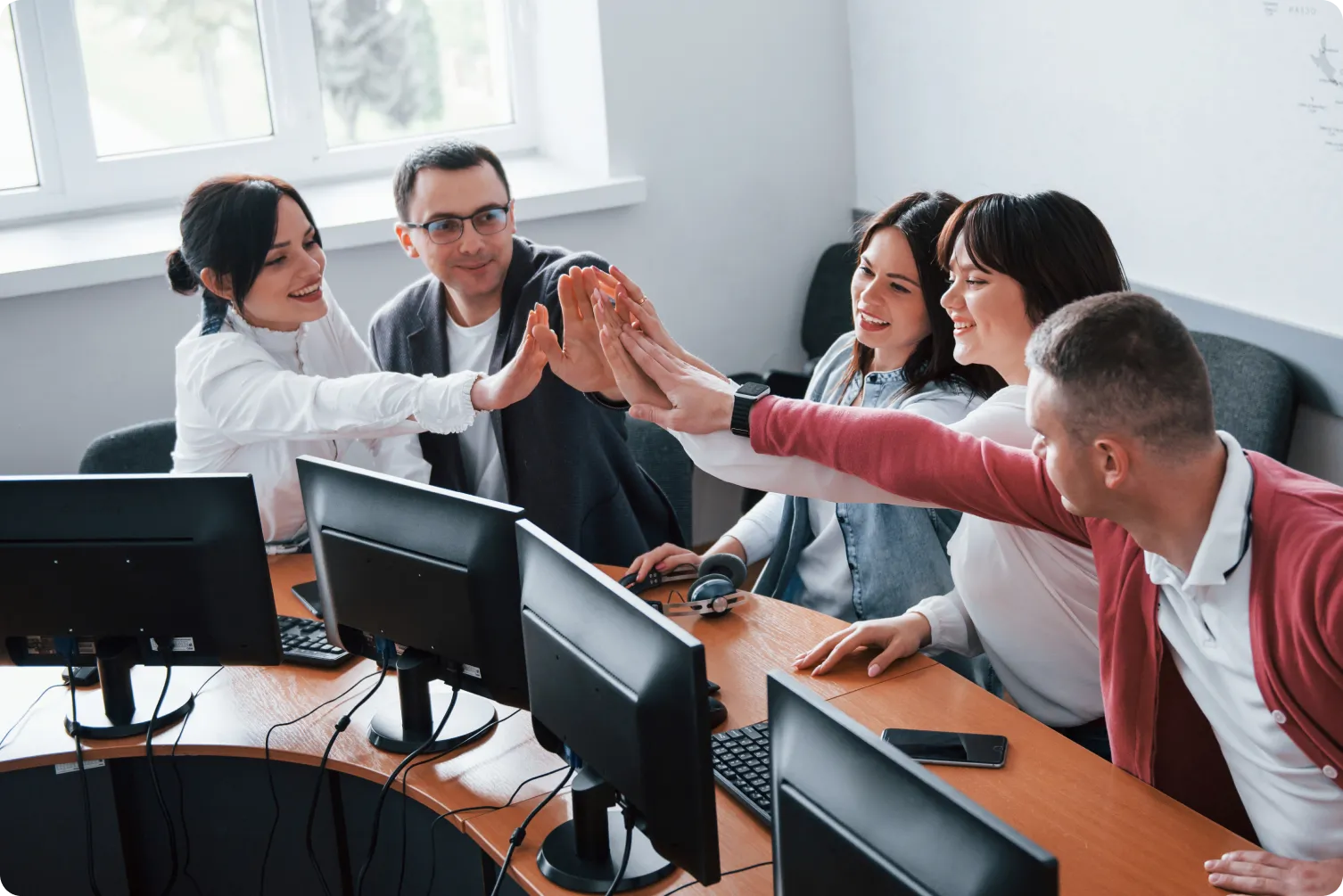 Faculty collaborating at computers during a faculty development program