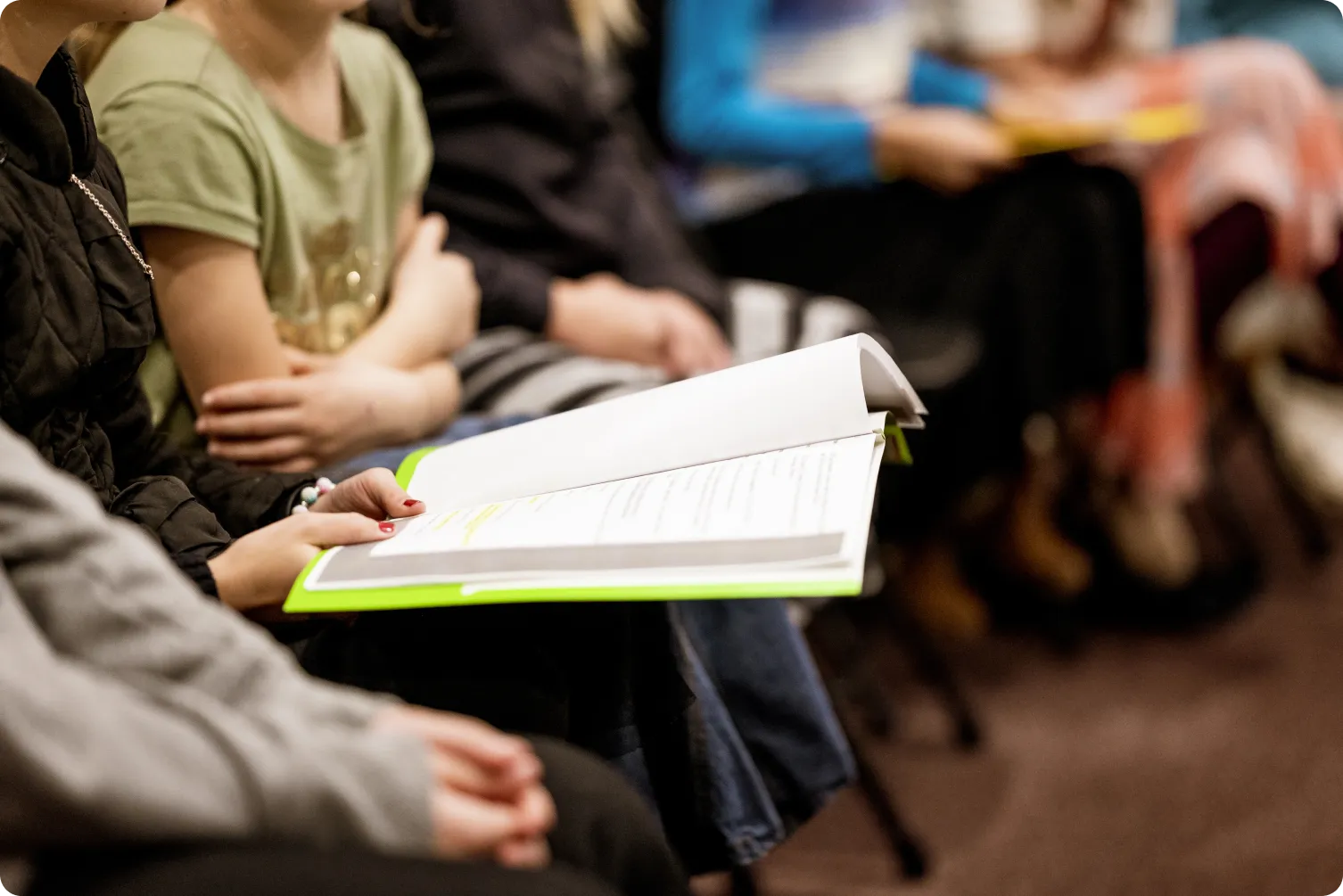 Students taking notes before guest lectures